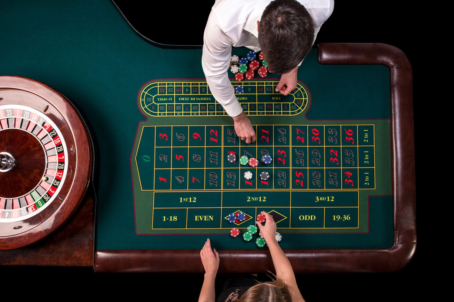 man-croupier-woman-playing-roulette-table-casino-top-view-roulette-green-table-with-tape-measure